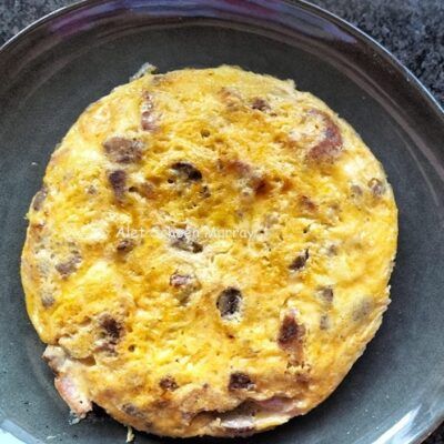 an omelet sitting on top of a black plate