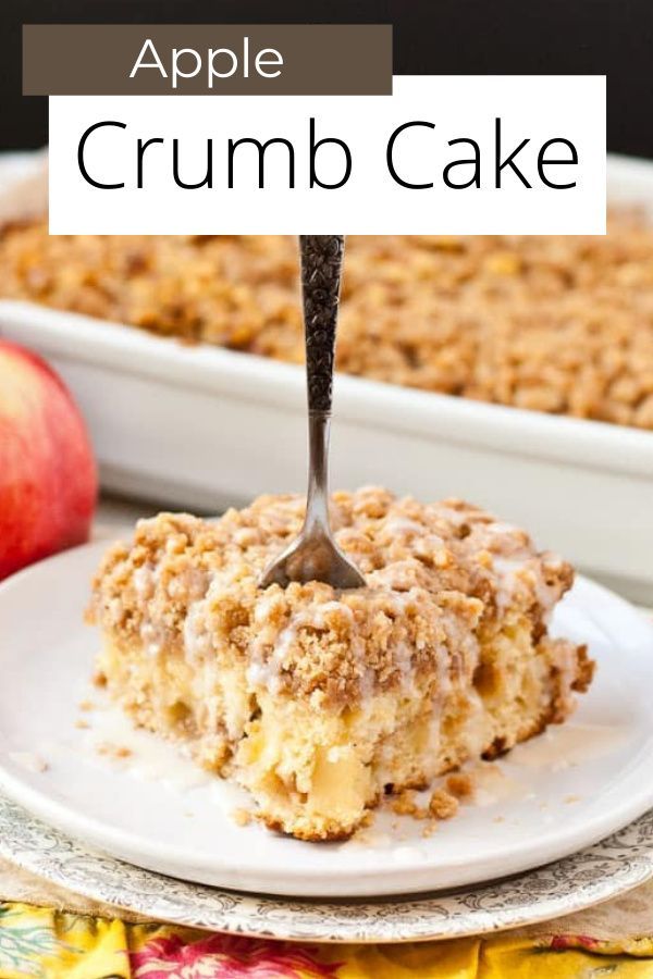 an apple crumb cake on a plate with a fork sticking out of the top