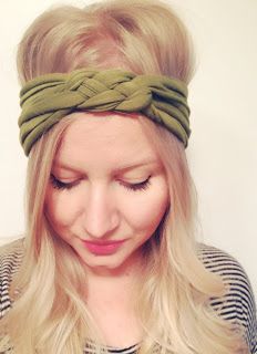 a woman with blonde hair wearing a green headband and looking down at her cell phone