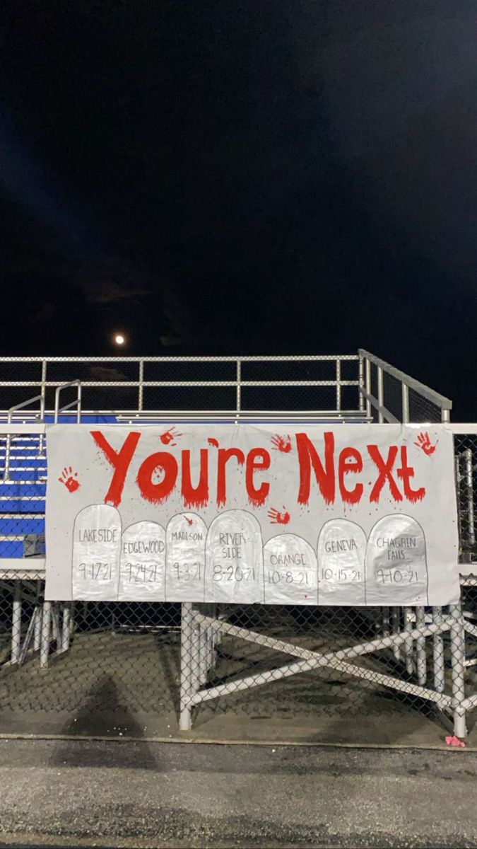 a sign that says you're next on the side of a fence