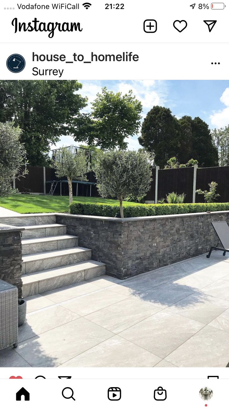 the instagram page shows an outdoor patio with steps leading up to it and landscaping in the background