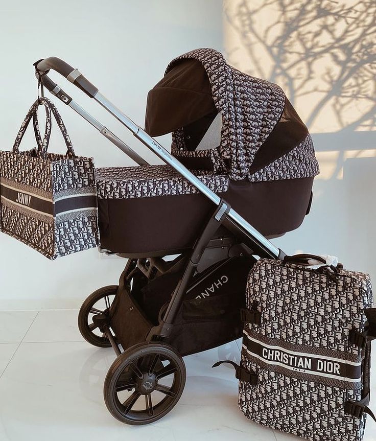 a baby stroller and some luggage on a white floor