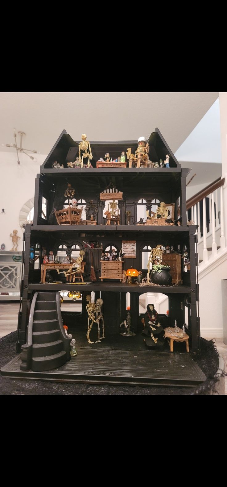 a doll house with lots of toys on top of it