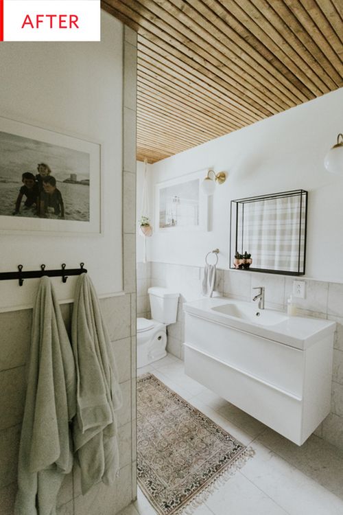 a bathroom with a rug, sink and bathtub in the middle of the room