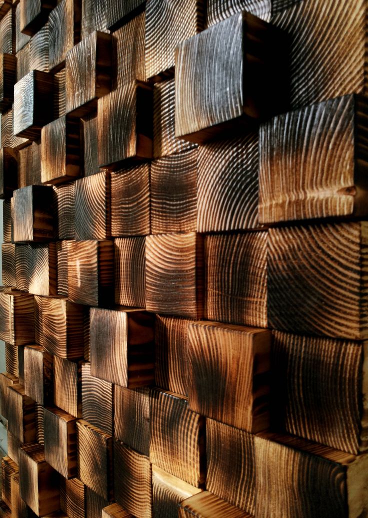 the wood has been cut into squares and arranged on top of each other in order to create an interesting wall decoration