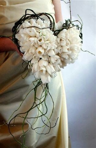 a bridal holding a bouquet of white flowers