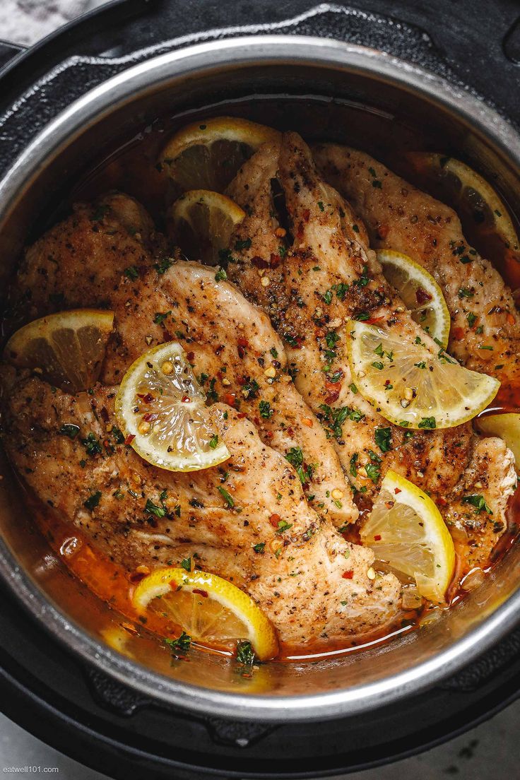 chicken with lemons and herbs in a slow cooker