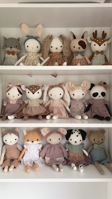 several stuffed animals sitting on top of white shelves