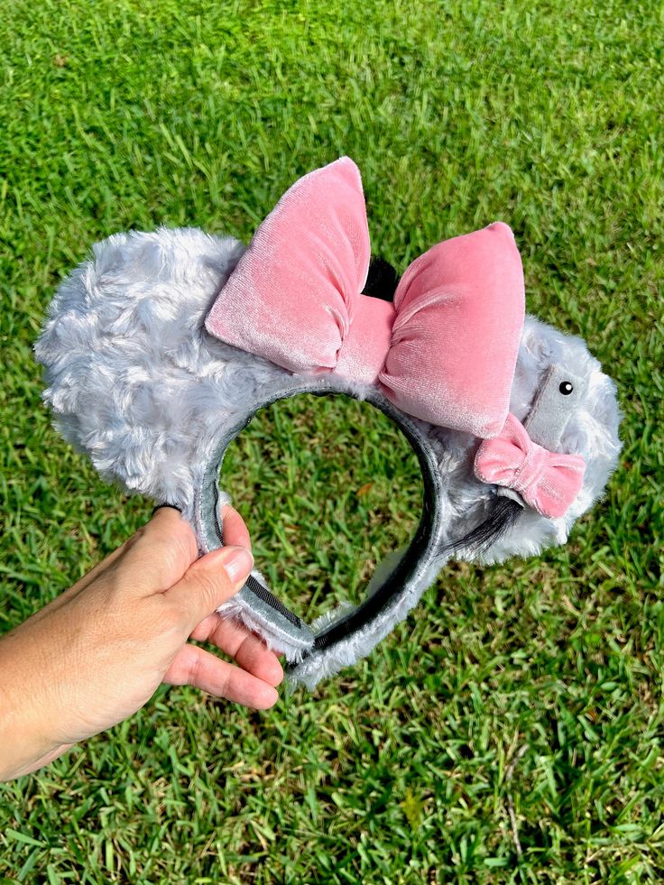 "Oh bother ... if you're a Winnie the Pooh fan and Eeyore pulls at your heartstrings the way he does to us, then these ears are for you! Made from a shimmery grey fluffy material and accessorized with a velvet pink bow, Eeyore's attachable tail, and a tuft of his hair on the back of the bow, these ears are perfect for hanging out in the Hundred Acre Woods! The headband is stitched with a non-slip velour so you ears will remain both comfortable and secure as you're off to fight heffalumps and woo Eeyore Disneybound, Disney Ears Hat, Ear Ideas, Diy Disney Ears, Diy Mickey Ears, Disneyland Ears, Disney Bows, Disney Mickey Ears, Hundred Acre Woods