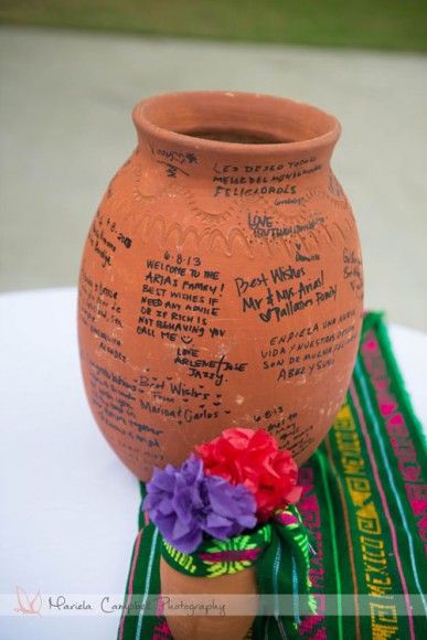 a vase with writing on it sitting on a table