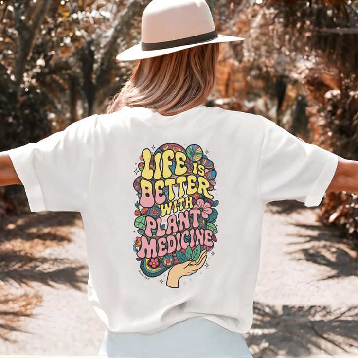 Embrace nature and groovy vibes with our "Life is Better with Plant Medicine" back-printed t-shirt. This trendy tee features a bold message and a unique retro design, perfect for expressing your love for natural remedies. Made from soft, high-quality cotton, it offers a comfortable and flattering unisex fit. Choose your favorite color t-shirt and spread positive, plant-powered vibes wherever you go! 💚 Material: 100% Cotton (fiber content may vary for different colors) Fabric Weight: Medium  Fit Summer Hippie T-shirt With Letter Print, Bohemian Letter Print Summer Tops, Groovy Relaxed Fit Summer Tops, Hippie Summer T-shirt With Screen Print, Summer Hippie T-shirt With Screen Print, Hippie Screen Print T-shirt For Summer, Hippie Style Summer T-shirt With Screen Print, Hippie Style Screen Print T-shirt For Summer, Groovy Summer Tops With Graphic Print