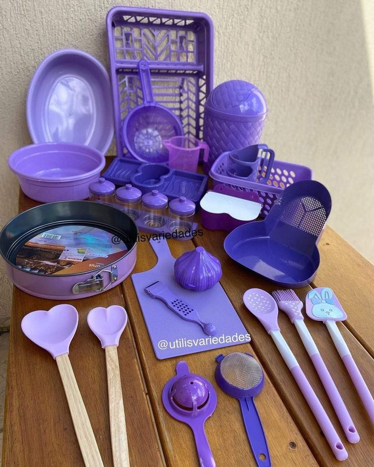 purple kitchen utensils on a wooden table