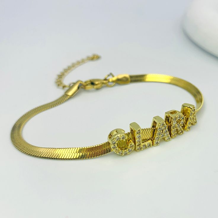 Customize it with any name or meaningful word to create a unique piece that tells your story. This luxurious bracelet showcases gold-tone letter charms on a sophisticated gold mesh band, combining timeless elegance with personalized flair. The adjustable clasp ensures a secure and comfortable fit. Gold Nameplate Chain Bracelet With Custom Name, Gold Adjustable Chain Bracelet With Nameplate, Gold Nameplate Bracelet With Adjustable Chain, Gold Nameplate Chain Bracelet With Name, Customizable Gold Metal Charm Bracelet, Elegant Gold Name Bracelet, Adjustable Gold Bracelets With Names, Gold Chain Bracelet With Custom Name For Personalized Gift, Trendy Personalized Gold Chain Bracelet