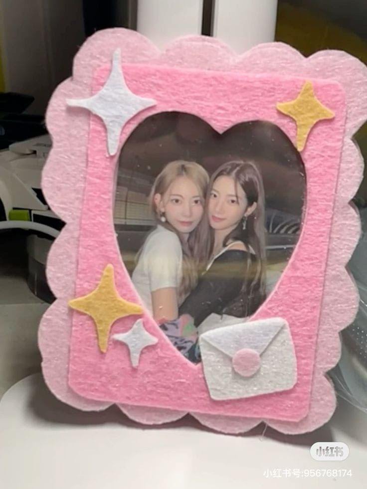 a pink frame with two girls in it