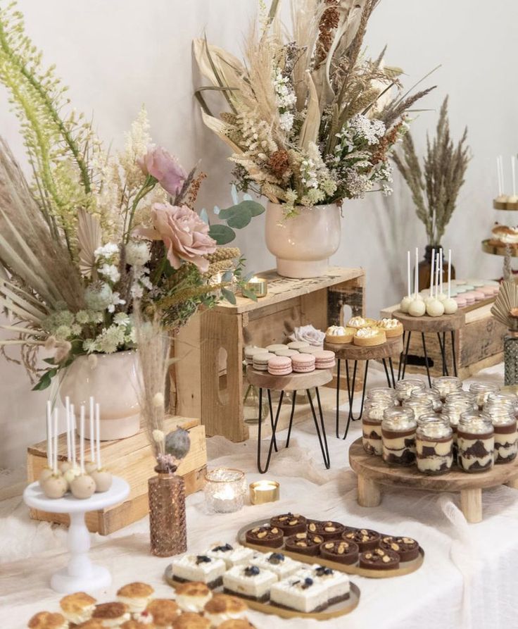 a table topped with lots of desserts and pastries