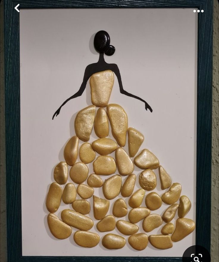 a woman standing on top of a pile of rocks next to a framed artwork piece