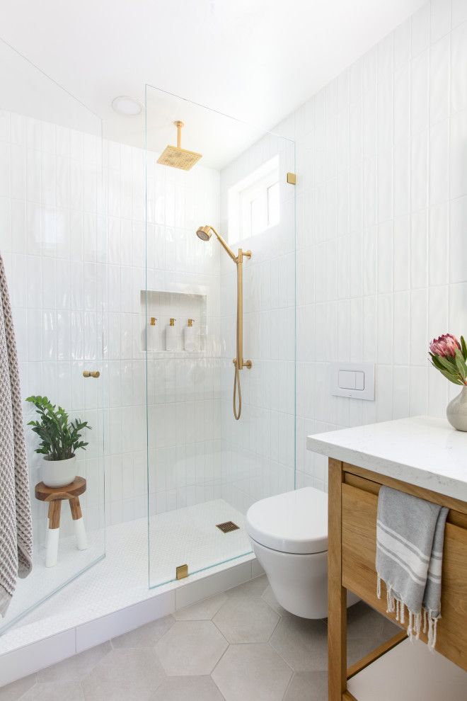 a bathroom with a toilet, sink and shower in it's center area is shown