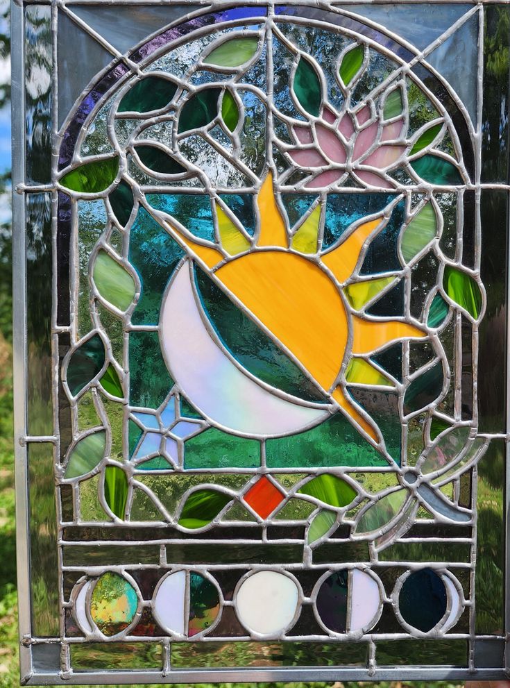 a stained glass window with the sun and moon on it