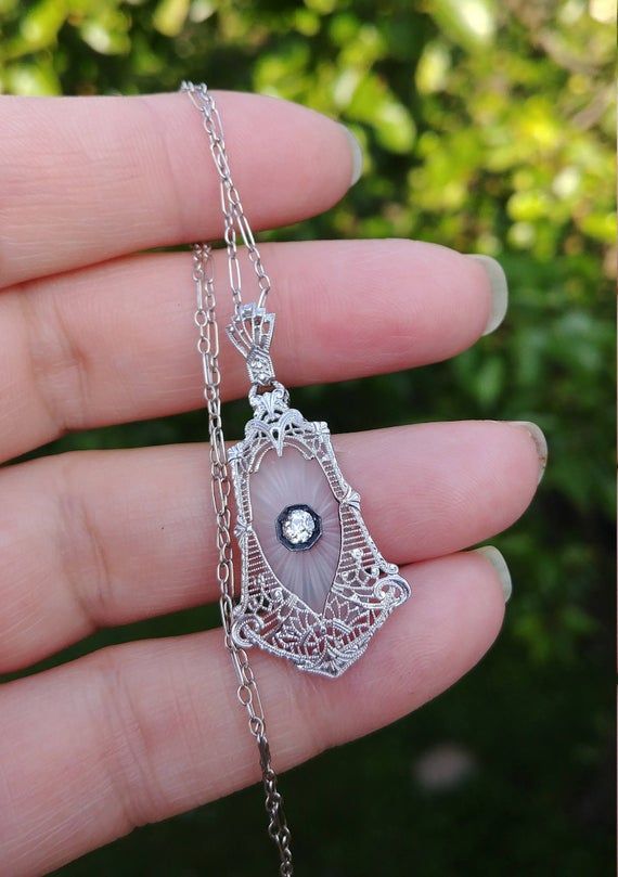 Stunning Art Deco Necklace, Pendant and Original Chain, made from 14k White Gold, approximately 0.15ct Old Mine Cut Diamond, Camphor Glass, Filigree design...Diamond is approximately 0.15ct, VS, GH..Perfect Antique Condition.All sales are final.Weight is 4.1 Grams.Layaway plan is Available..Some pics Enlarged to see details. Art Deco Necklace Pendant, Camphor Glass Jewelry, Bijoux Art Deco, Bijoux Art Nouveau, Vintage Jewelry Antique, Old Mine Cut Diamond, Filigree Necklaces, Retro Ring, Art Deco Necklace