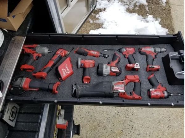 a tool box filled with tools on top of snow covered ground