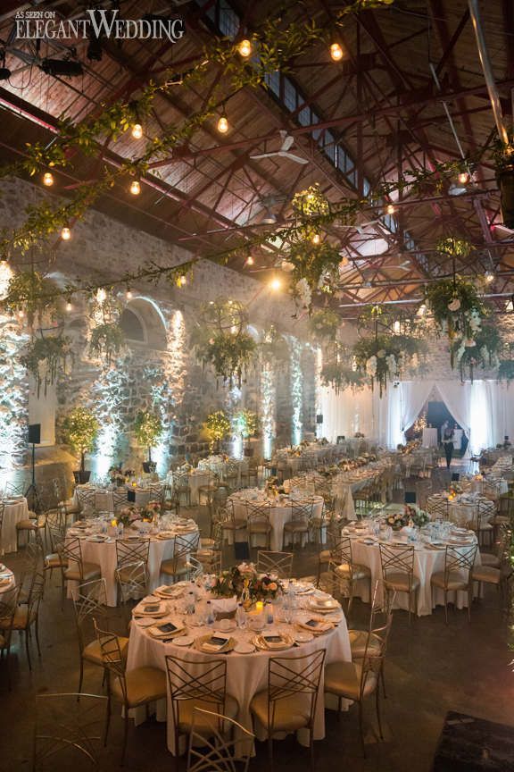 an indoor wedding venue with tables and chairs