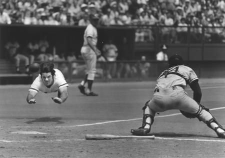 an old black and white photo of a baseball player sliding into home plate while the catcher is ready to catch the ball