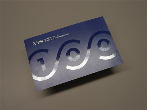 a close up of a business card on a gray surface with the word c o g written in white