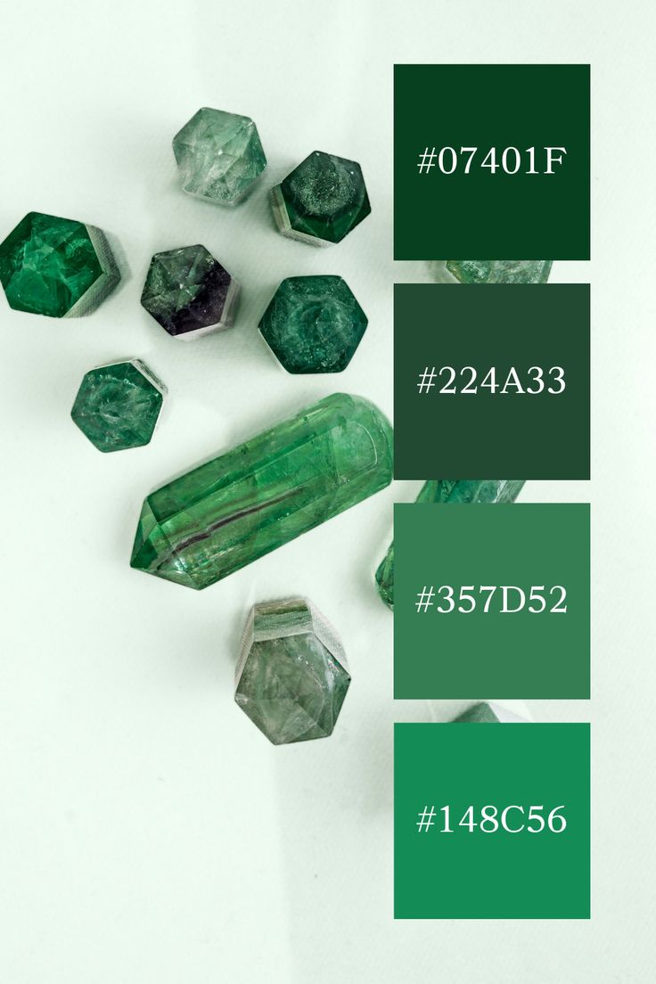 some green and white crystals are next to each other with numbers on the bottom side