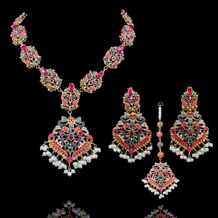 Nauratan timelessness that carry distinct style, intricacy and craftsmanship of a bygone era! Adorn charisma with this talismanic set studded with ethereal stones and the grace of pearl moti along with the radiance of traditional and aesthetic identity. The set includes a necklace, a maang teekah and a pair of stunning earrings. Approximate earrings length is 3.5". Gold-plated on high-quality brass as base metal. Made by order. Kindly allow 5-7 weeks for the delivery of this item. For custom or Heritage Jewellery, Bygone Era, Faux Stone, Waist Chain, A Necklace, Head Accessories, The Grace, Stunning Earrings, Mozambique