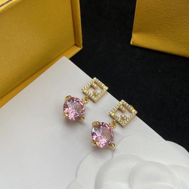 Make a statement with the Pink Polished Earrings from Micha Jewelry. Expertly crafted using only the most luxurious materials, these earrings shine with their 18k gold finish and eye catching pink diamond. The diamond simulants add a touch of brilliance and sparkle, ensuring that these earrings capture the attention of all who see them. SHOP MORE DESIGNS AT SHOPMICHA.COM Fendi Earrings, Fendi Jewelry, Punk Accessories, Jewelry Simple, Classic Earrings, Wedding Party Jewelry, Diamond Simulant, Simple Jewelry, Gold Fashion