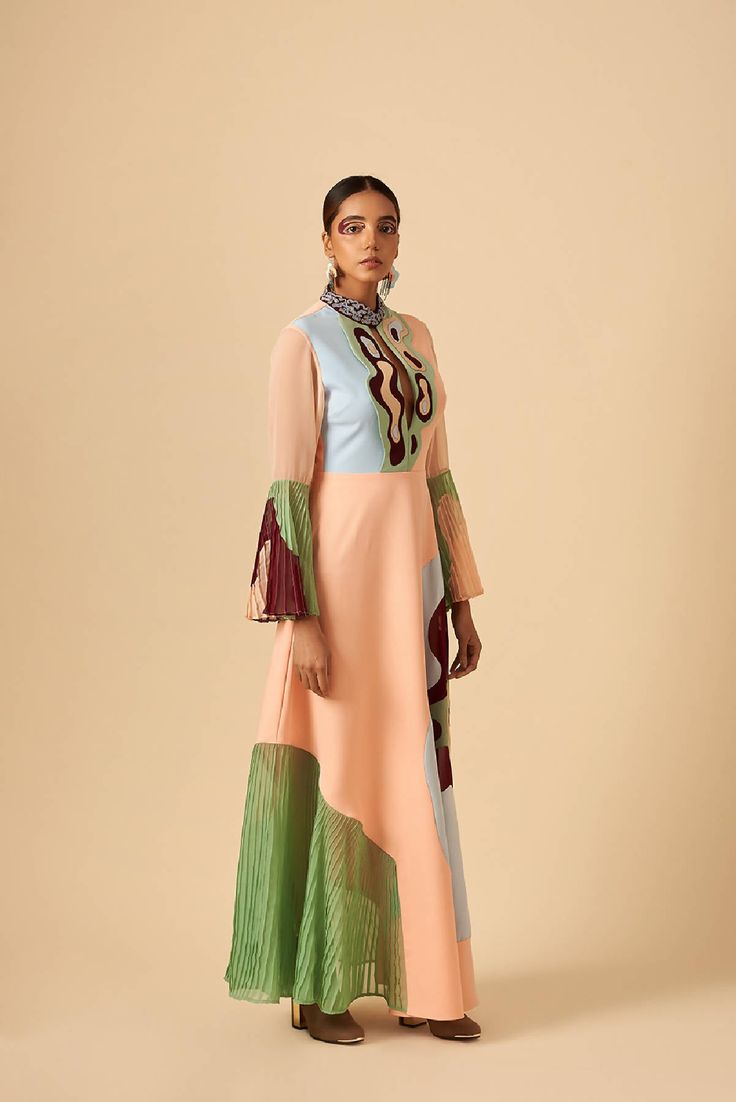 This timeless silhouette dress portrays the breath of spring summer freshness. Valley of blush, our go-to outfit with flared sleeves and high collar; deep plunge neckline. Vale of soft hues, delicately pleated georgette and embroidery details creates a sense of grace and sophistication. Back zip closure. Shell: Poly Crepe, IndiaShell: Poly Georgette, IndiaShell: Fauxe Suede, IndiaLining: Poly Rayon, India Made in IndiaDry-clean onlyModel is wearing UK 8, Height 179cm Bohemian Georgette Dress With Cape Sleeves, Georgette Dress With Ruffles And Cape Sleeves, Georgette Maxi Dress With Cape Sleeves, Bohemian Evening Dress In Georgette, Bohemian Georgette Evening Dress, Pink Floor-length Dress With Draped Sleeves, Pink Floor-length Dresses With Draped Sleeves, Pink Georgette Dress With Cape Sleeves, Feminine Long Sleeve Georgette Dress