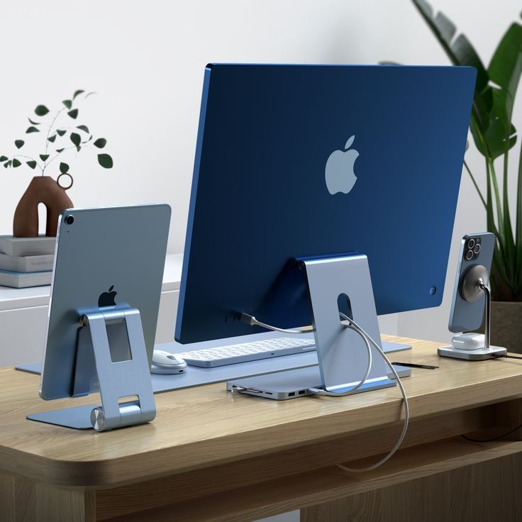 an apple computer sitting on top of a wooden desk