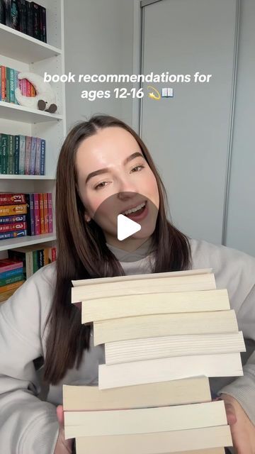 a woman holding stacks of books in front of her face with the caption book recommendnations for ages 12 - 16