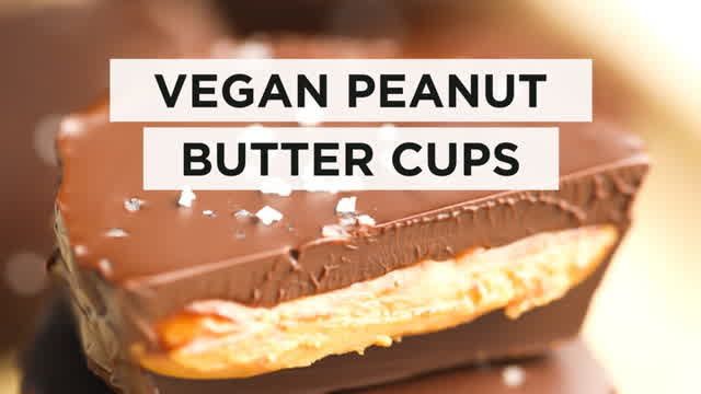 a close up of a piece of chocolate with the words vegan peanut butter cups on it