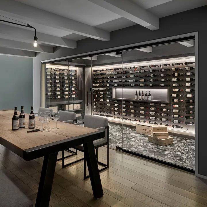 a room with a table and bottles of wine