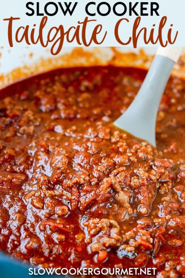 slow cooker tailgate chili in a blue pot with a ladle scooping out