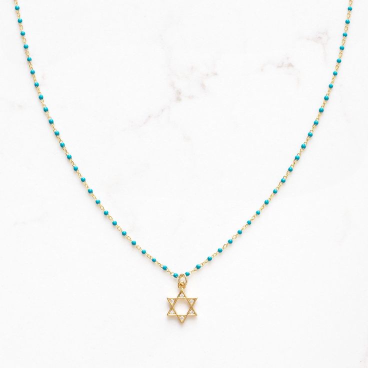 "Dainty Star of David necklace on sterling and gold plated, enamel beaded chain.  Adjustable 16-18\"	in stock	45.00 USD	"	4.00 USD	Jewelry > Necklaces > Charm Necklaces
"	top_seller_high	false	https://www.etsy.com/listing/1584979972/star-of-david-magen-david-necklace-for	adult	etsy://listing/1584979972?ref=applinks_android	stitchandstonedesign	Black	new	en-US	"	false	unisex	0.67	Apparel & Accessories > Jewelry > Necklaces	https://i.etsystatic.com/6649757/r/il/b16bbe/5451198694/il_fullxfull.54511 Star-shaped Beaded Chain Necklace For Gift, Star-shaped Jewelry With Beaded Chain For Gifts, Gold Necklaces With Star Charm And Round Beads, Gold Necklace With Star Charm And Round Beads, Star-shaped Beaded Necklace For Gift, Magen David Necklace, Star Of David Necklace, Necklace Top, Enamel Beads