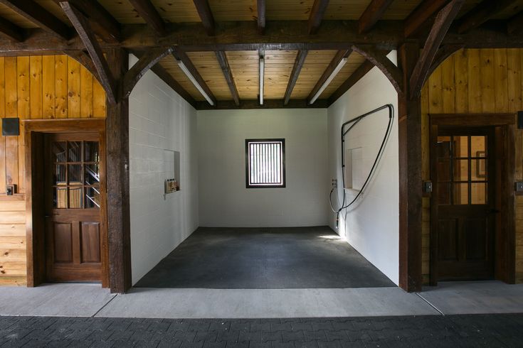 an empty room with wooden walls and doors