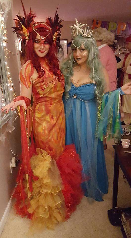 two women dressed in costumes standing next to each other