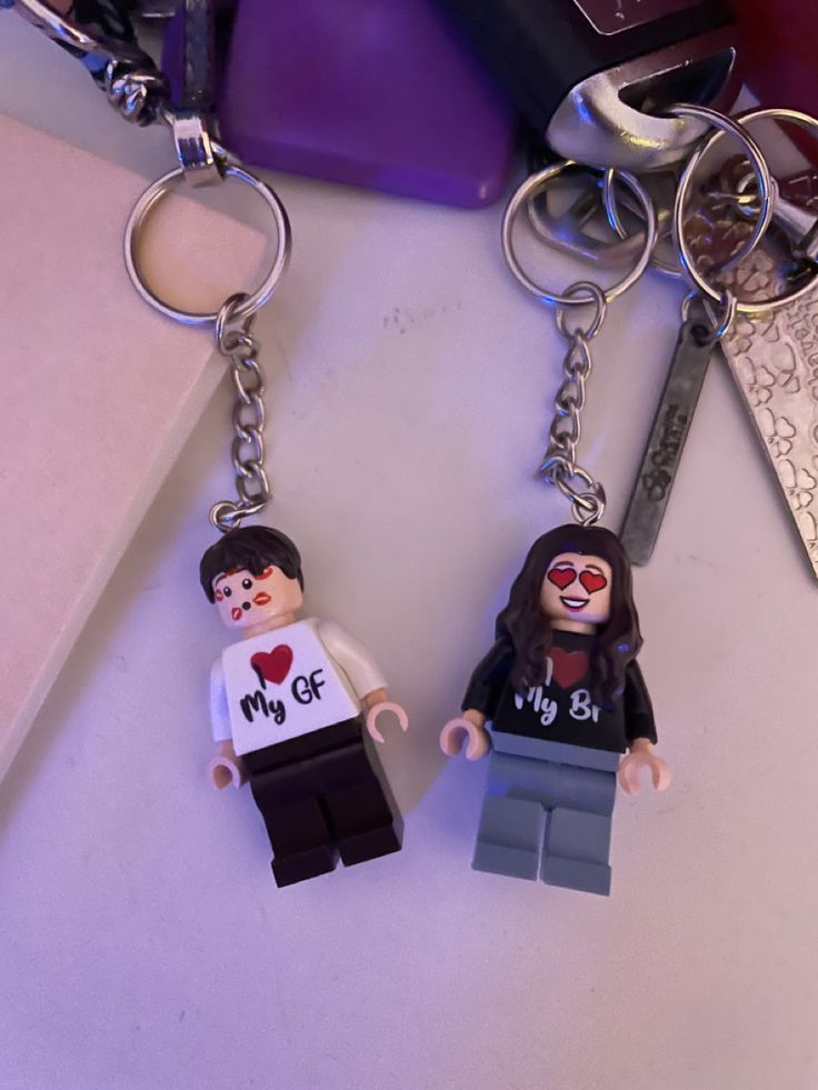 two lego keychains that have been placed next to each other