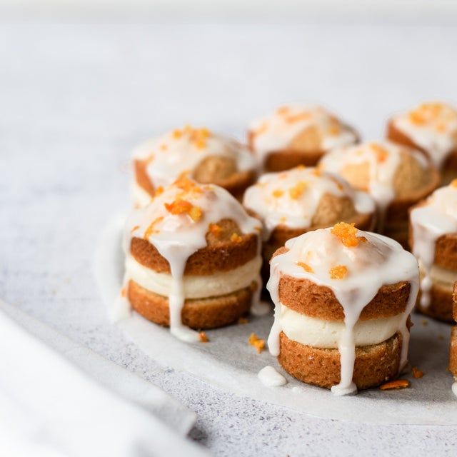 small desserts with icing and orange zest on a plate