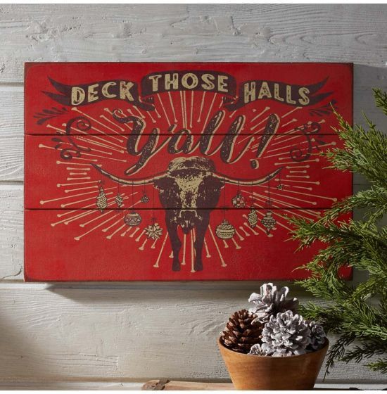 a wooden sign that says deck those hills with an image of a cow on it