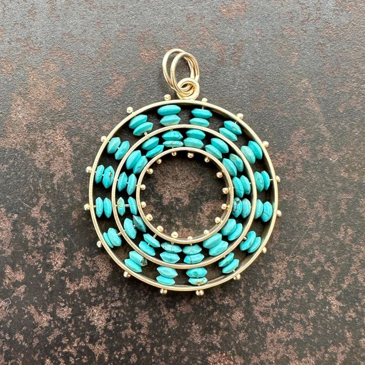 This pendant is a true standout. Vibrant Persian turquoise beads are arranged in captivating concentric circles, creating a timeless yet contemporary design. Warm and luxurious 14k gold complements the turquoise beautifully. Designed to impress, this modern relic seamlessly transitions from casual to formal, making it a versatile addition to your jewelry collection. This listing is for the pendant only. For a full necklace, pair with one of Hilary's chains, linked here. 1 inch diameter. 14k gold Modern Turquoise Round Jewelry, Modern Round Turquoise Jewelry, Turquoise Jewelry With Round Spacer Beads, Elegant Round Turquoise Necklace With Large Pendant, Persian Turquoise, Concentric Circles, Turquoise Beads, Circles, Contemporary Design