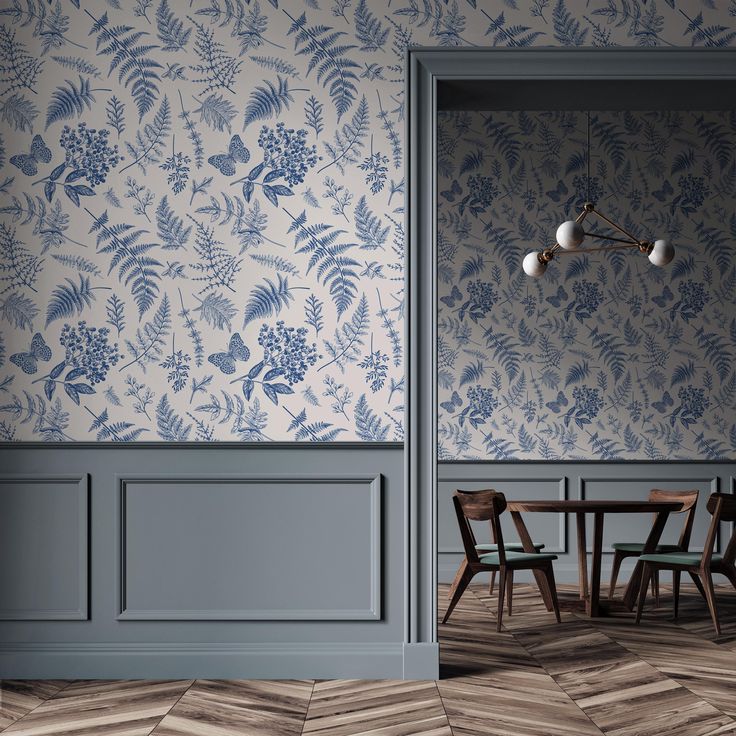 a dining room with blue and white wallpaper