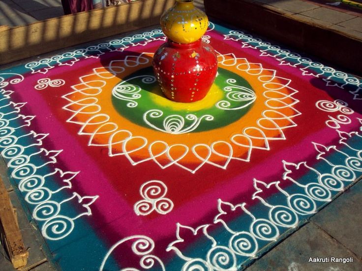 a brightly colored rug with a yellow bird on top and an orange vase in the middle