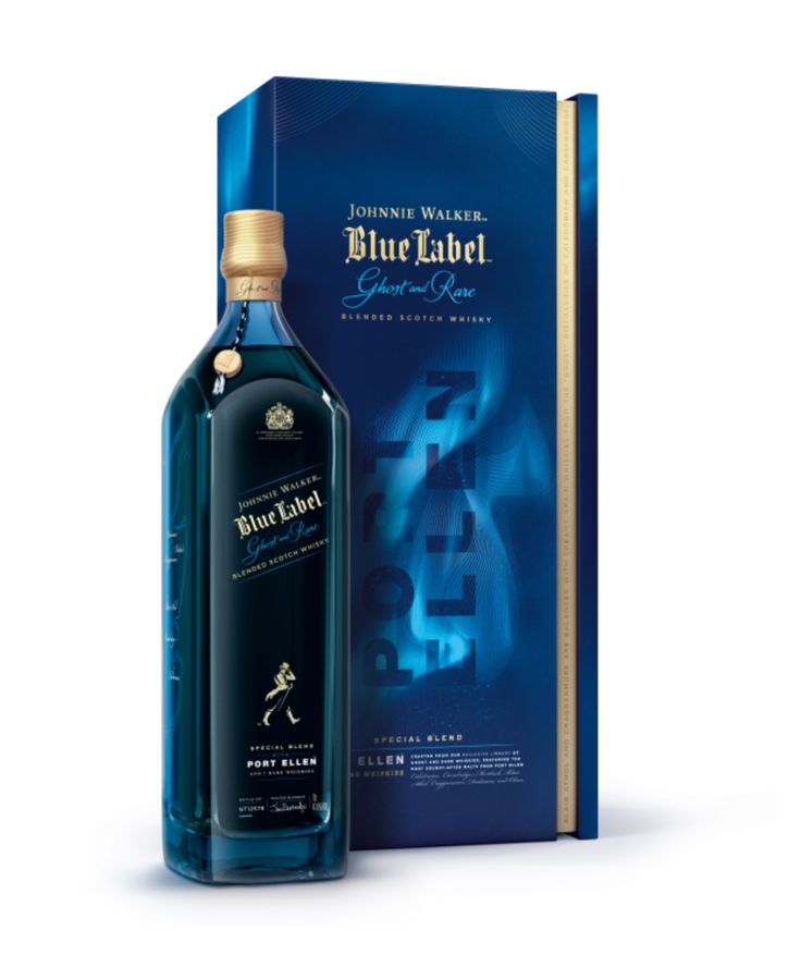 a bottle of blue label whisky sitting next to a book and an open box on a white background