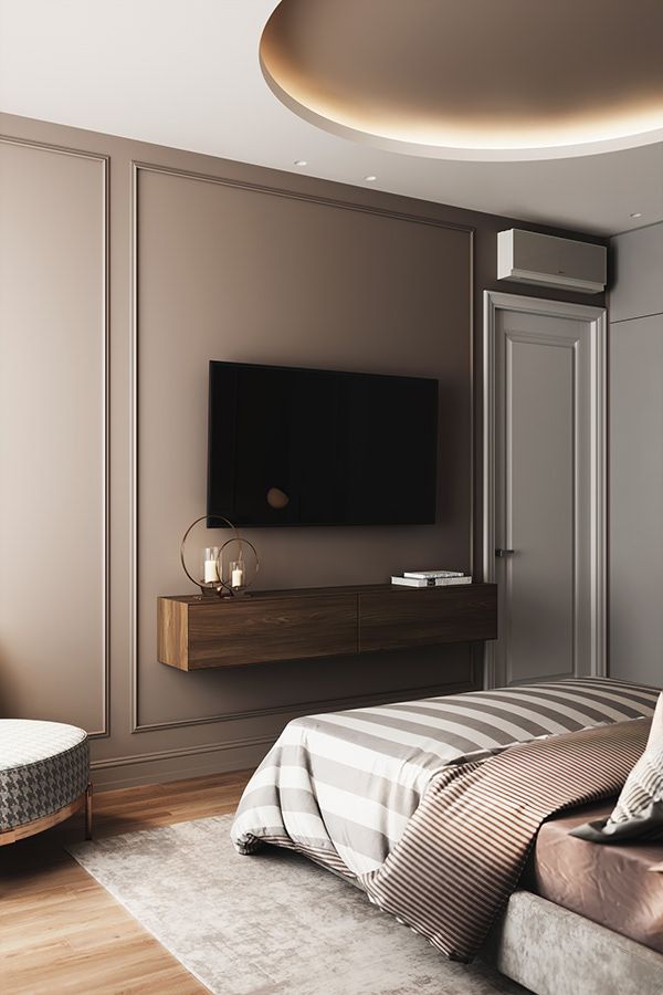 a bedroom with a large bed and a flat screen tv mounted on the wall above it