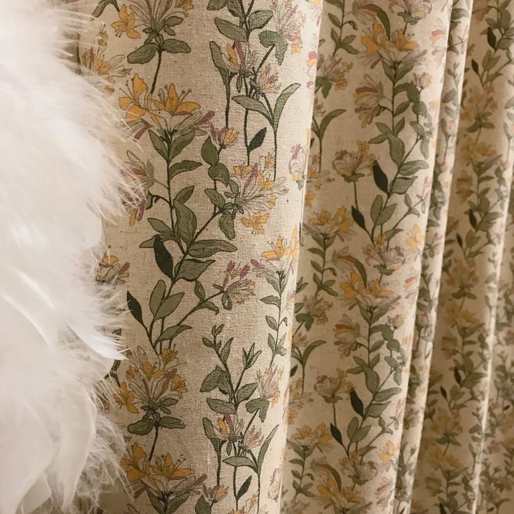 the curtains are decorated with flowers and feathers