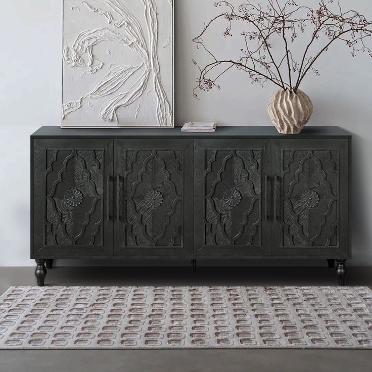 a vase sitting on top of a black cabinet