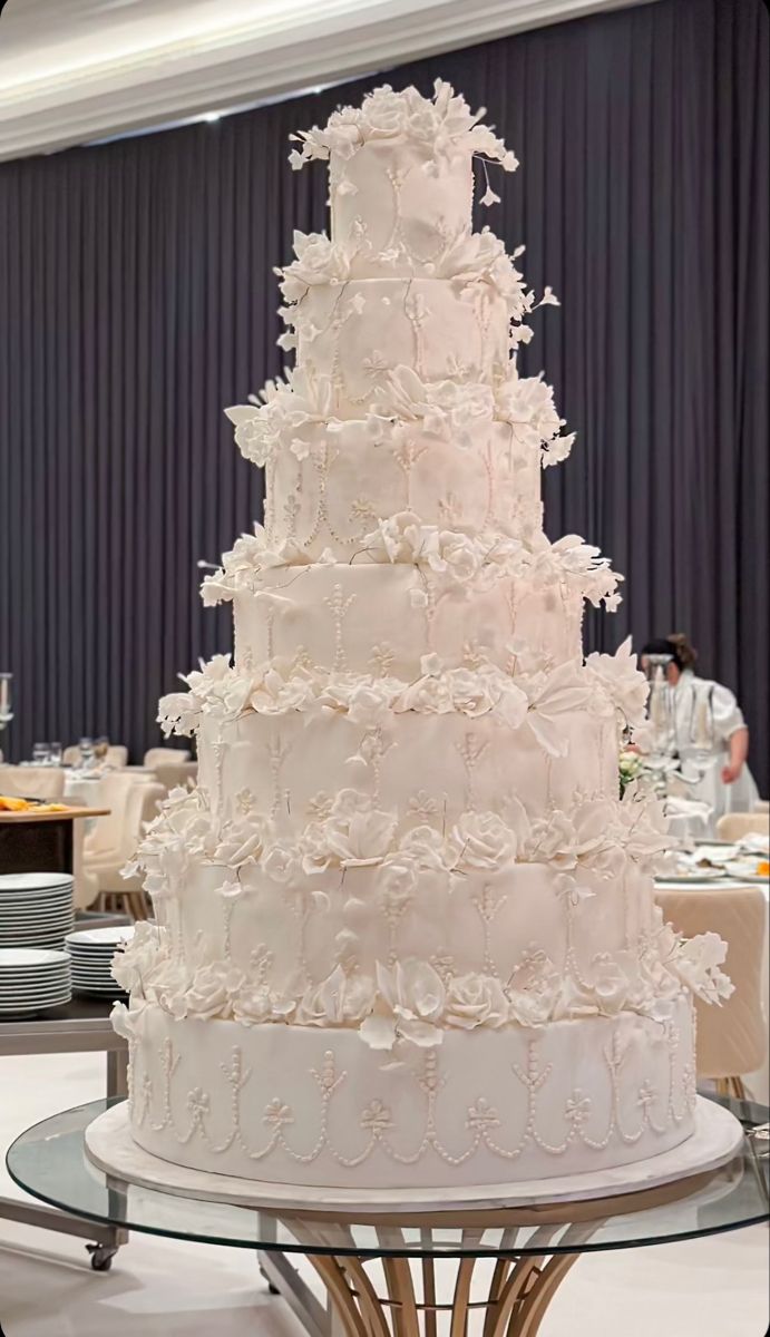 a large white wedding cake sitting on top of a table